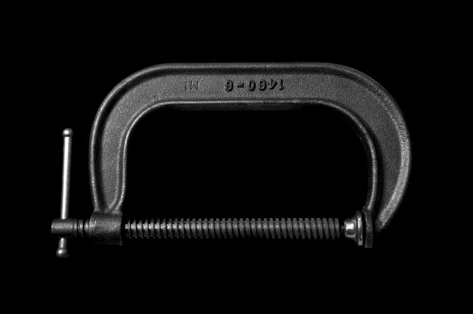 G clamp on a black background.