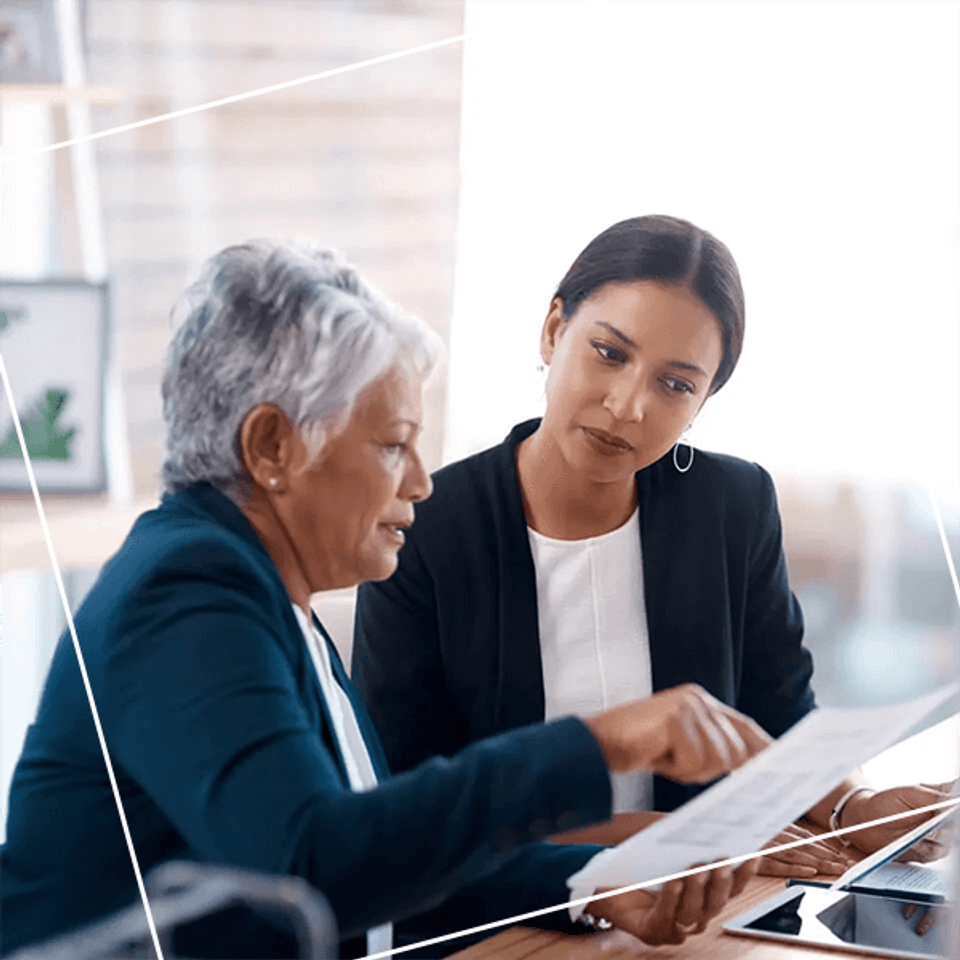 Two women discusing a document