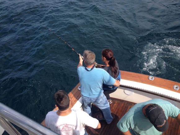 Ma woman fishing from stern with safety equipment on