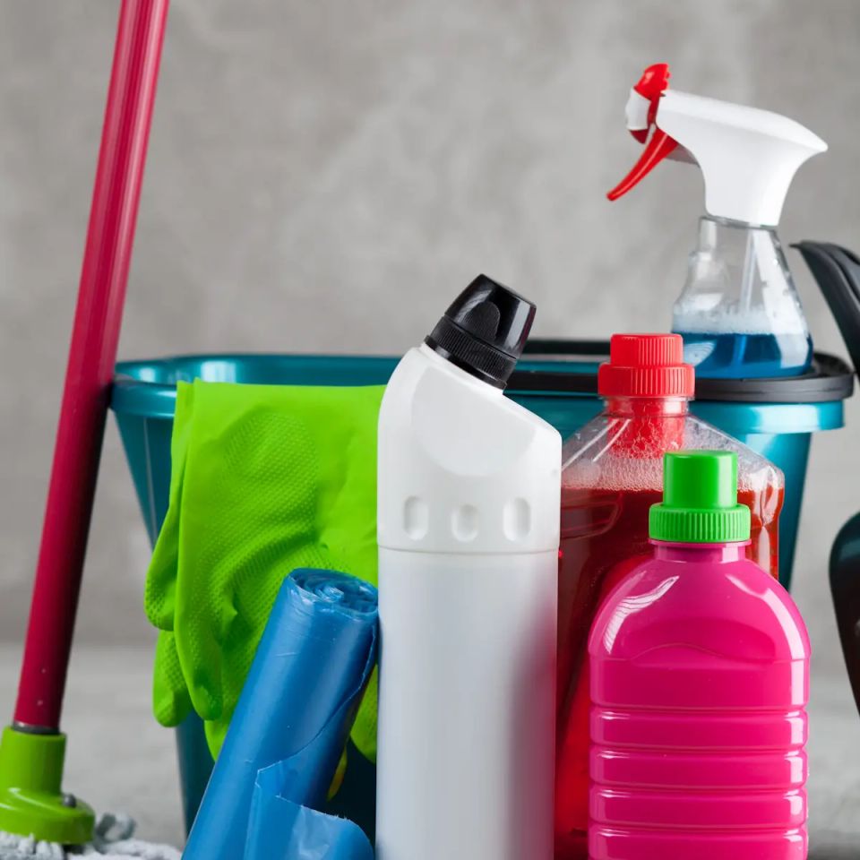 Bucket of colorful cleaning supplies and spray bottles for house cleaning service in Virginia Beach VA