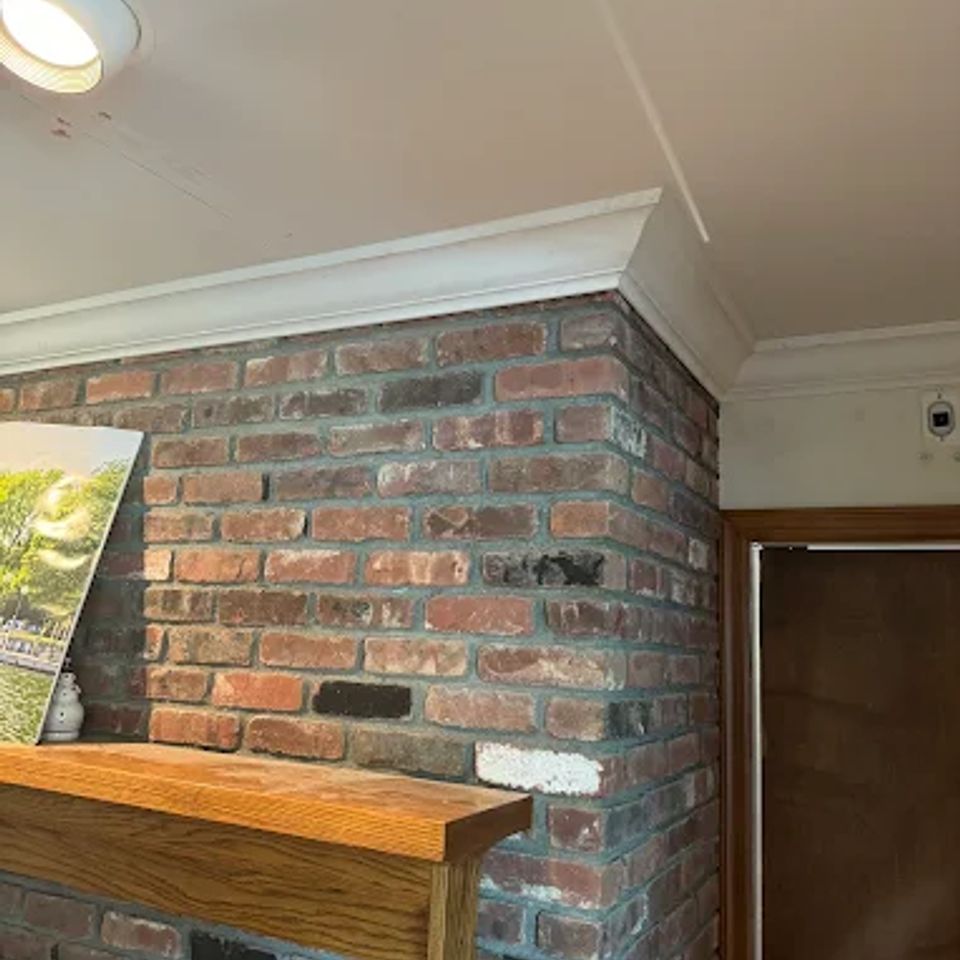 Photo of wooden shelf attached to brick, done by Taurus Contracting of Suffolk County, NY