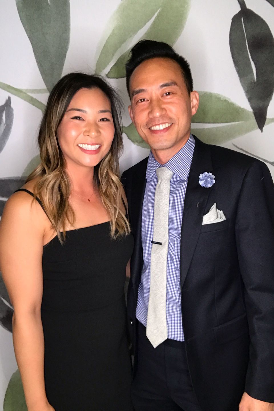 Stylish couple smiling for a photo booth picture.