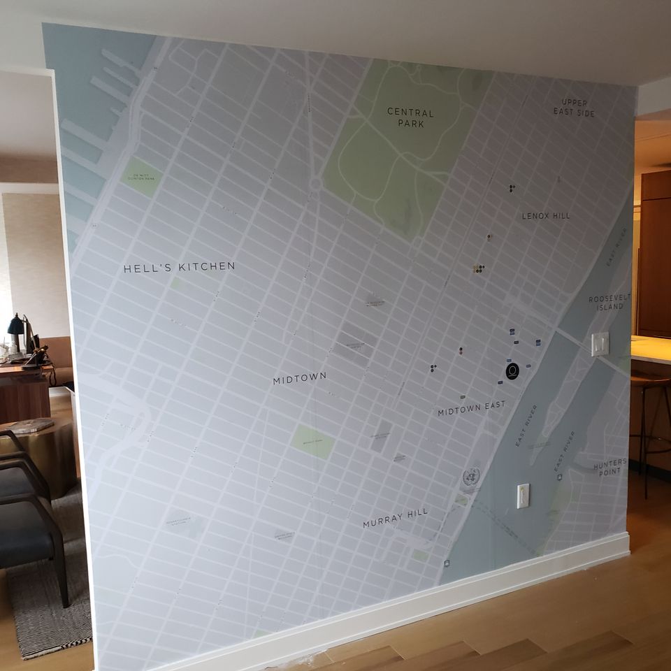 Printed vinyl wall graphic of a city street map covering an interior wall from floor to ceiling