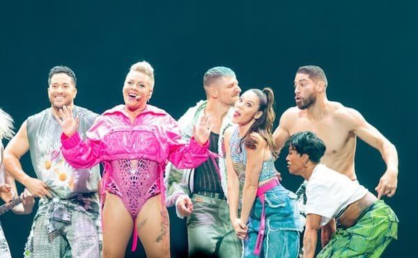 Pink in a hot pink get up with her dancers 
