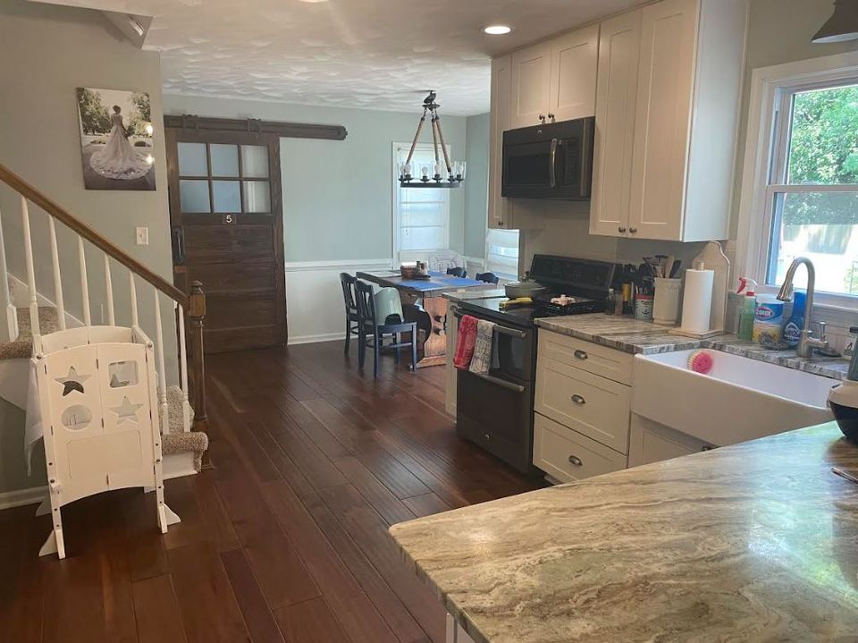 Freshly cleaned open kitchen with hardwood floors and tidy countertops after a house cleaning service in Virginia Beach VA