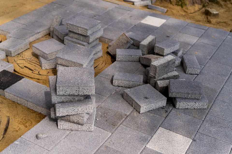 Premium building materials and stacked bricks prepared for a custom masonry installation or retaining wall project by Roseville Concrete Solutions.