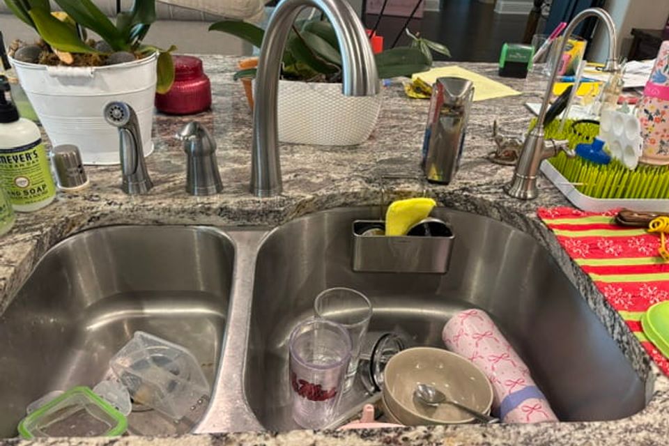 Kitchen sink and surrounding counter area before cleaning