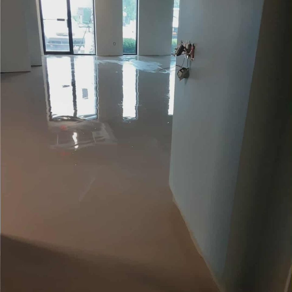 Smooth, reflective concrete flooring in an open commercial interior.