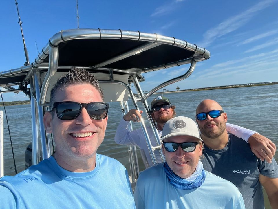 Fishing group selfie on charter boat enjoying sunny day Charleston SC