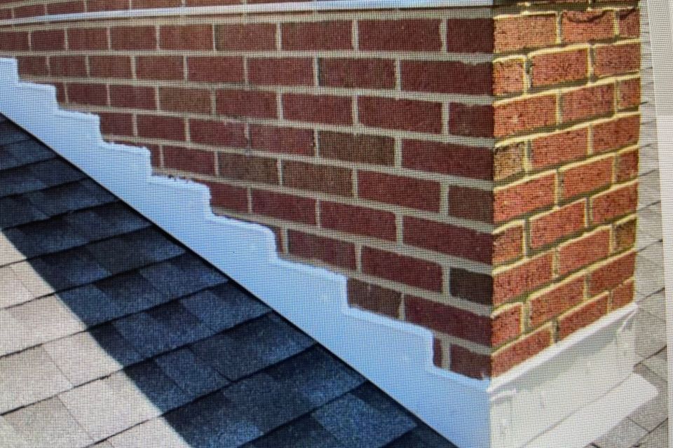 Chimney with newly installed flashing designed to help prevent roof leaks and water intrusion.