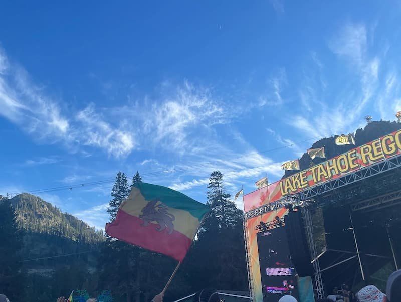 Lake Tahoe Reggae Festival with Jamaica flag flying with a blue sky background at the Palisades, CA 