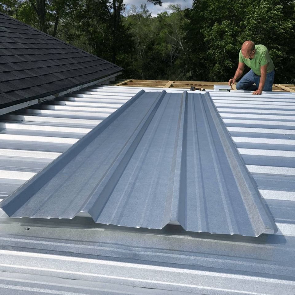 Contractor installing corrugated metal roofing on a residential roof