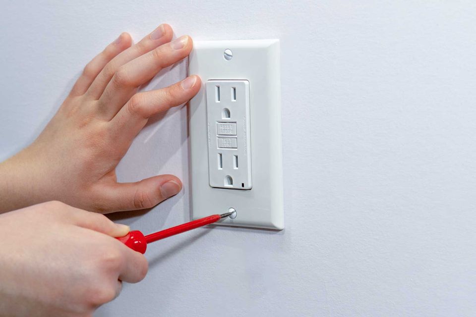 Homeguide handyman replacing electric outlet cover plate