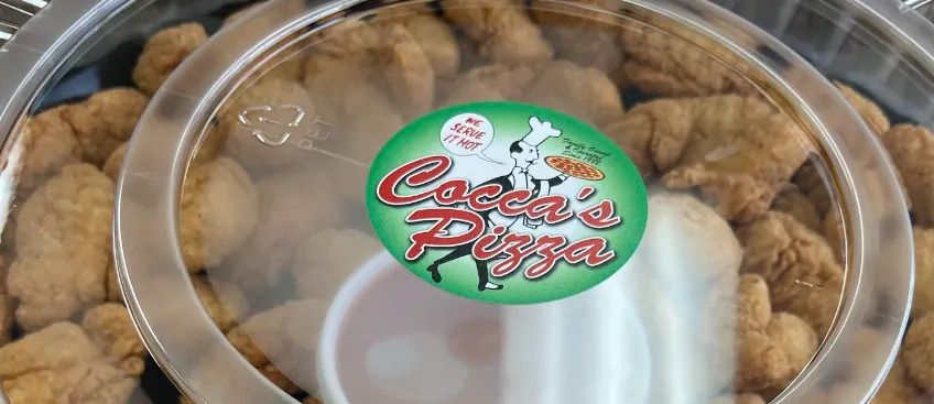 Container of golden-brown bite-sized pizza snacks with a Cocca’s Pizza label.