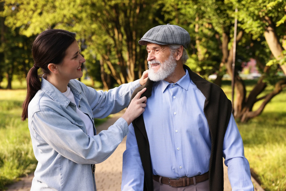 Caregiver guiding senior walking