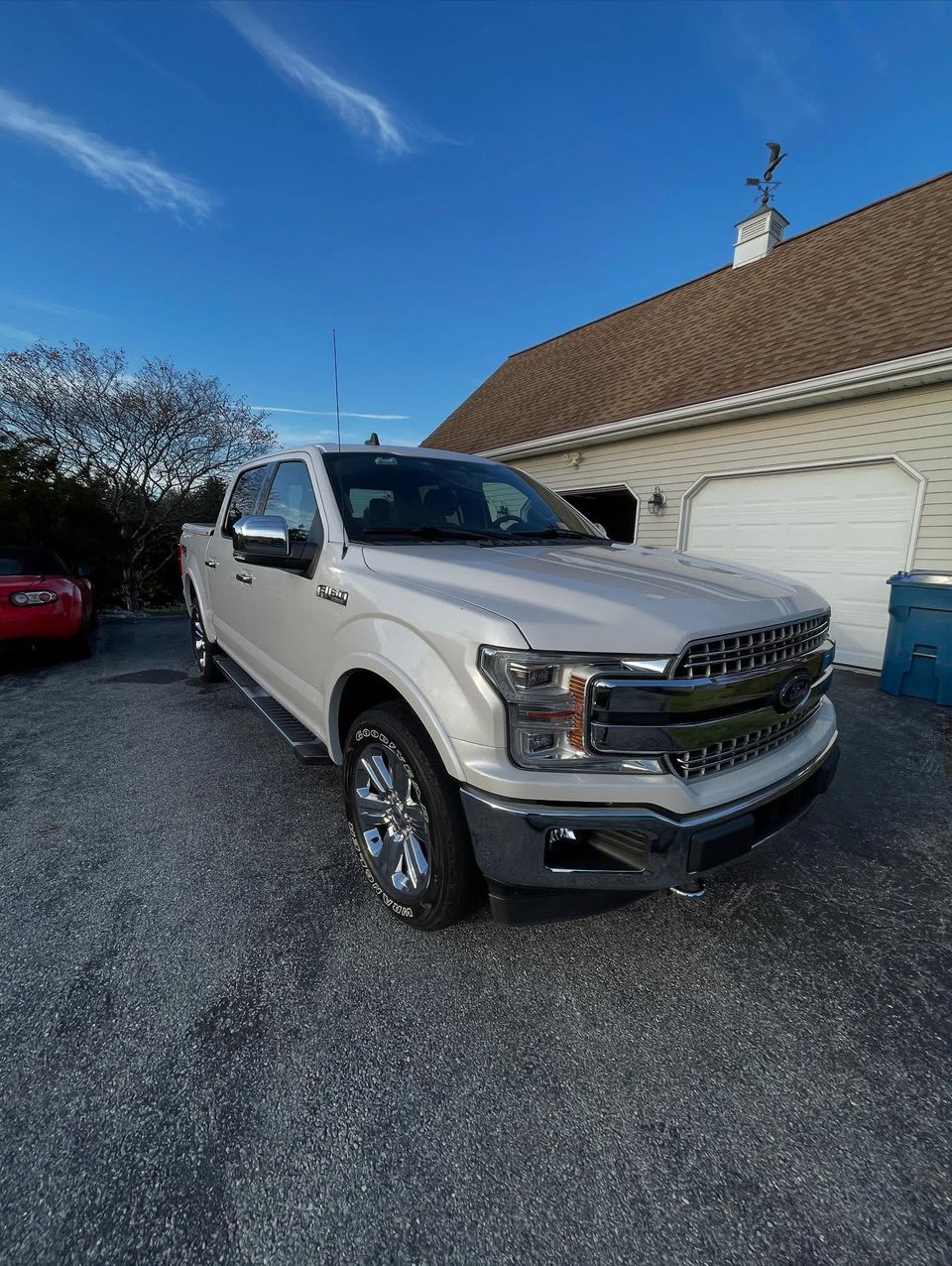 White Ford F-150 Lariat crew cab with chrome grille shining after a driveway detail in Wilmington DE