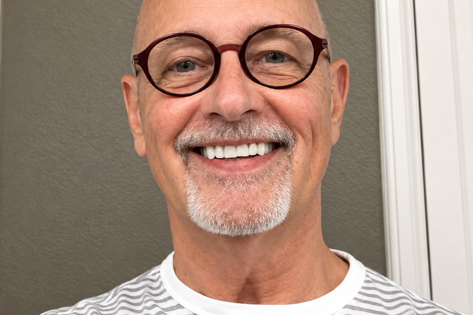Smiling man in round glasses