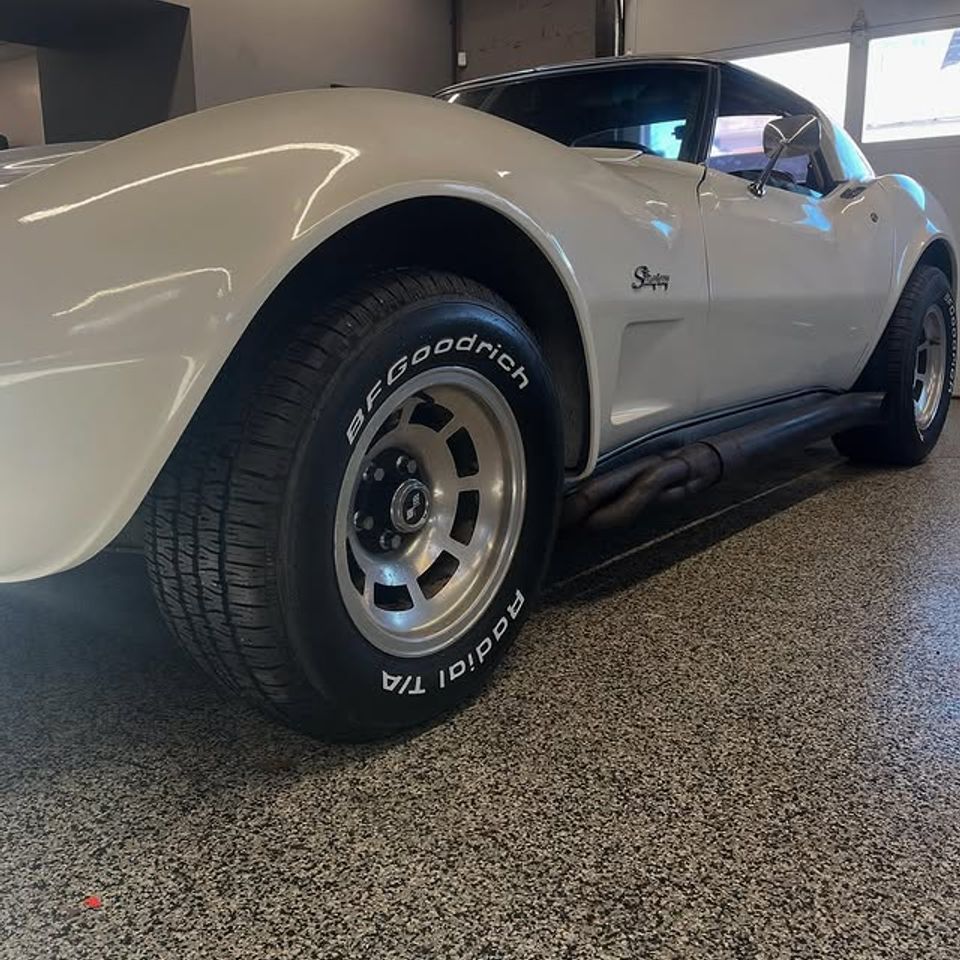 White Chevy Corvette Stingray with BFGoodrich Radial T/A tires inside tire shop in Claymont DE