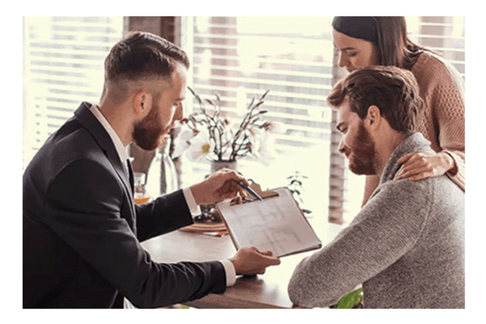 Couple reviewing paperwork with agent