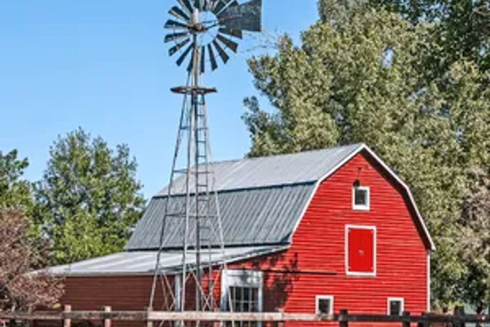 Red farm house with windmill