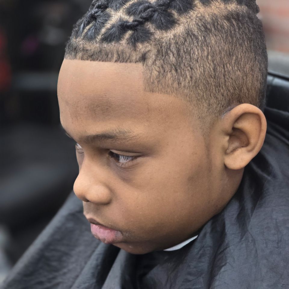 Young client receiving edge up and fade haircut at Bronx NY barbershop Jeff Barber Services