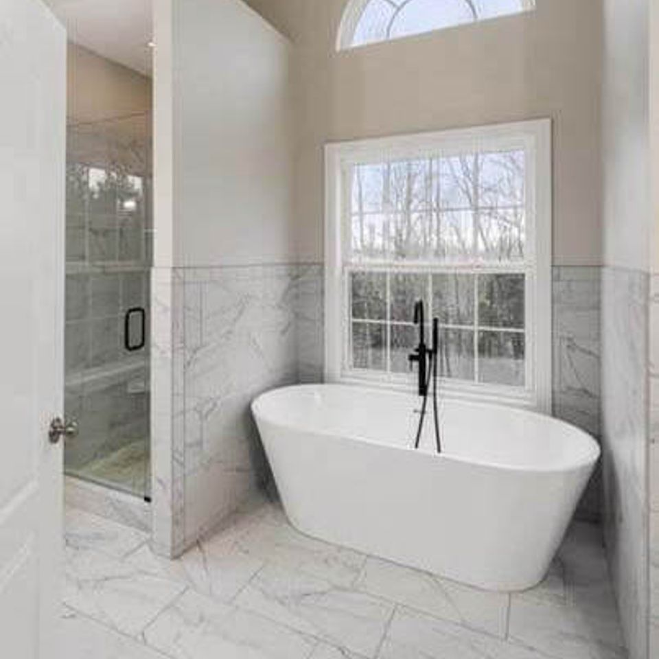 Luxurious bathroom renovation featuring a freestanding tub and double vanity in Knoxville TN