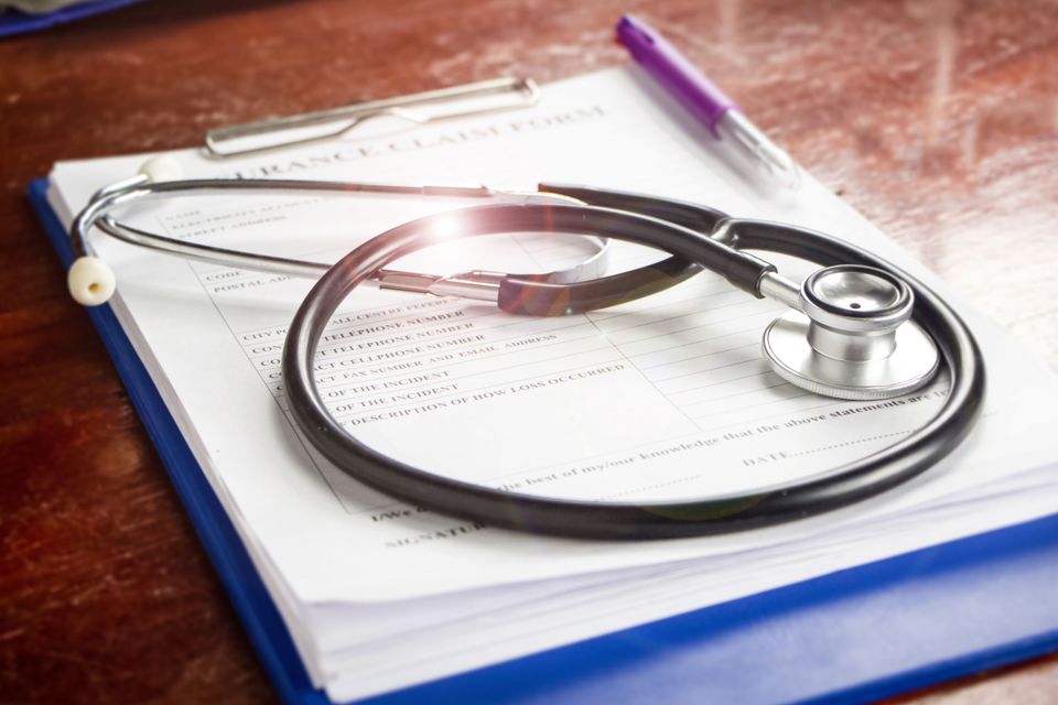 Vistacreate 377323530 stock photo stethoscope put blurred insurance claim form lens flare effect blurry