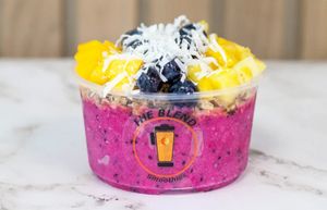Pink Today! bowl with pitaya base, mango, blueberries, pineapple, granola, coconut, and agave drizzle.