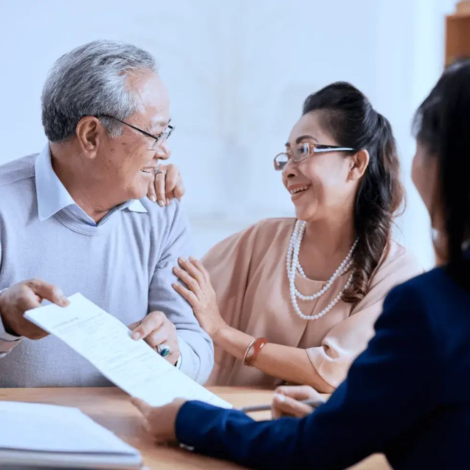 Happy elderly couple paperwork