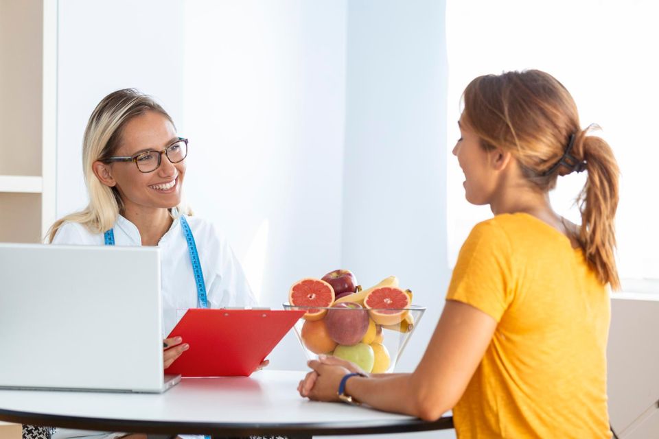 Female nutritionist giving consultation patient making diet plan 1212 7246