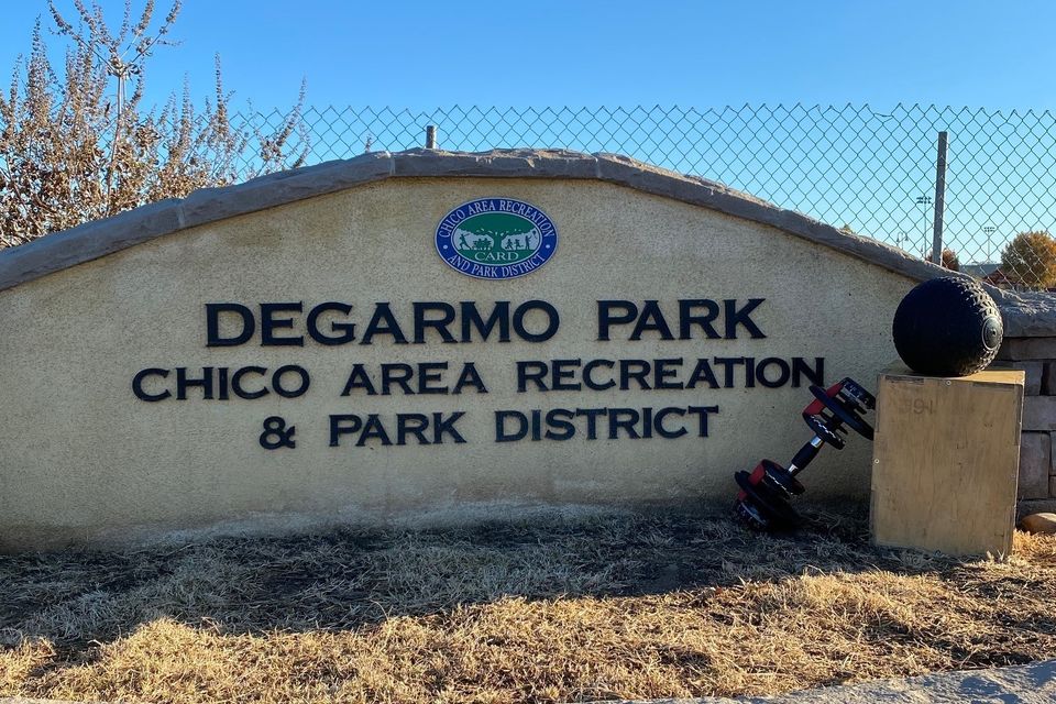 Image with exercise equipment next to the sign at the entrance to DeGarmo Park in Chico Ca