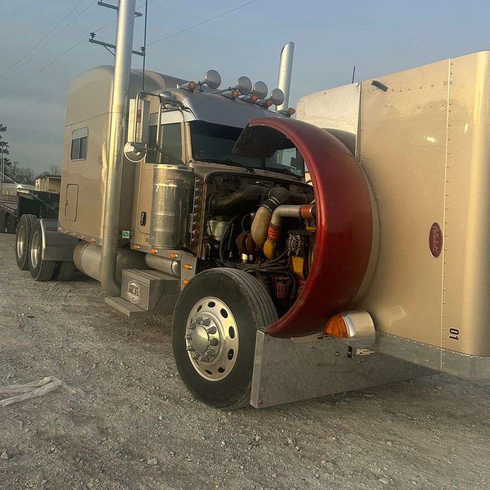 Tan Peterbilt semi-truck with hood tilted open for diesel engine service in Arab Alabama