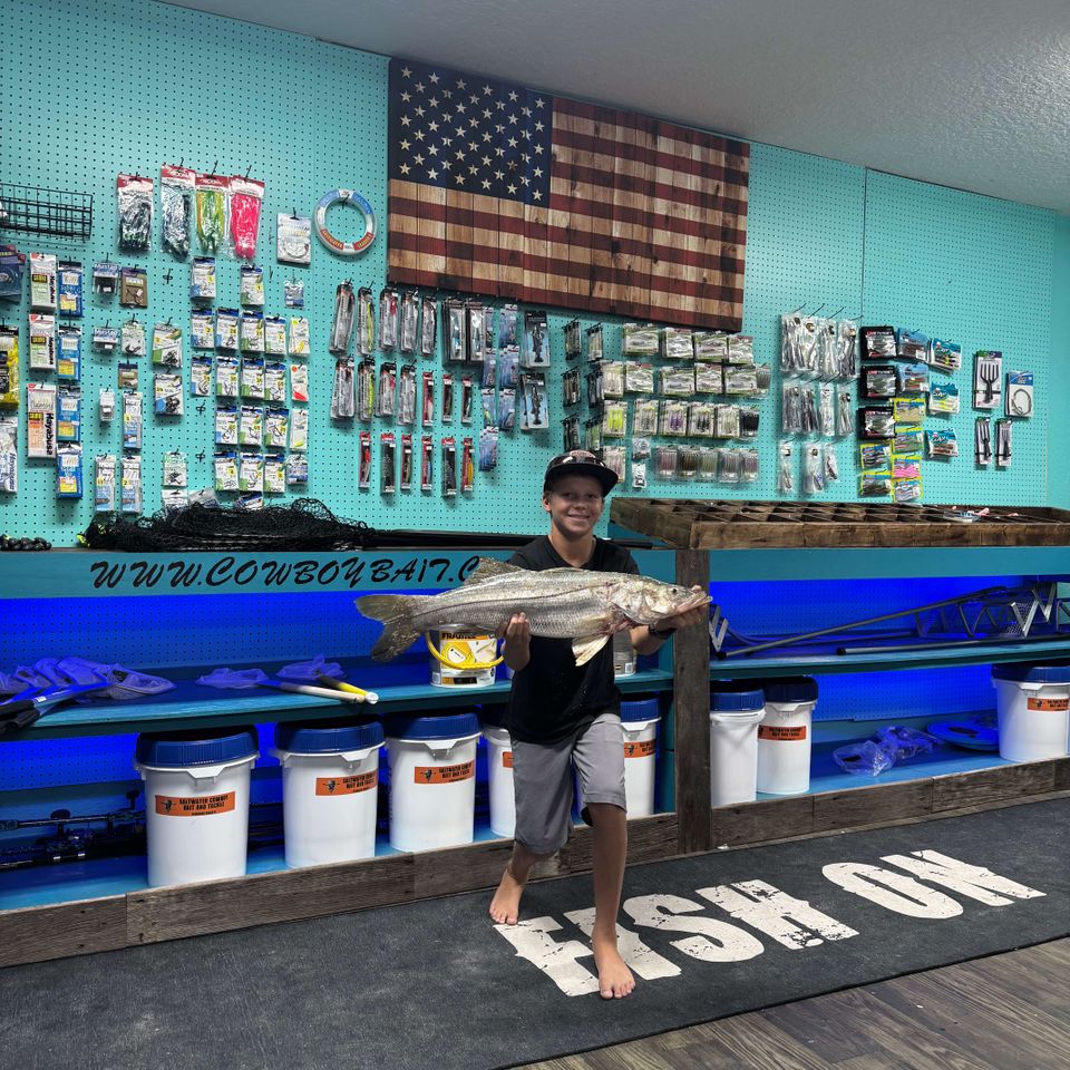 Boy holding a big fish at the Saltwater Cowboy Bait Shop