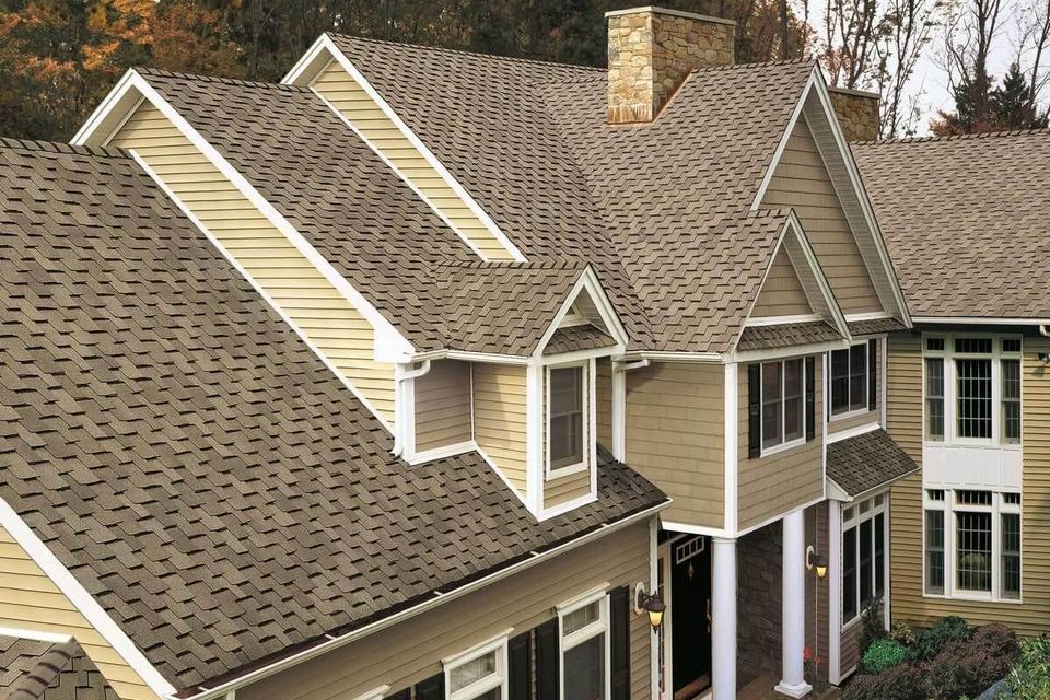 Asphalt shingles on a traditional home with vinyl siding 1200x916