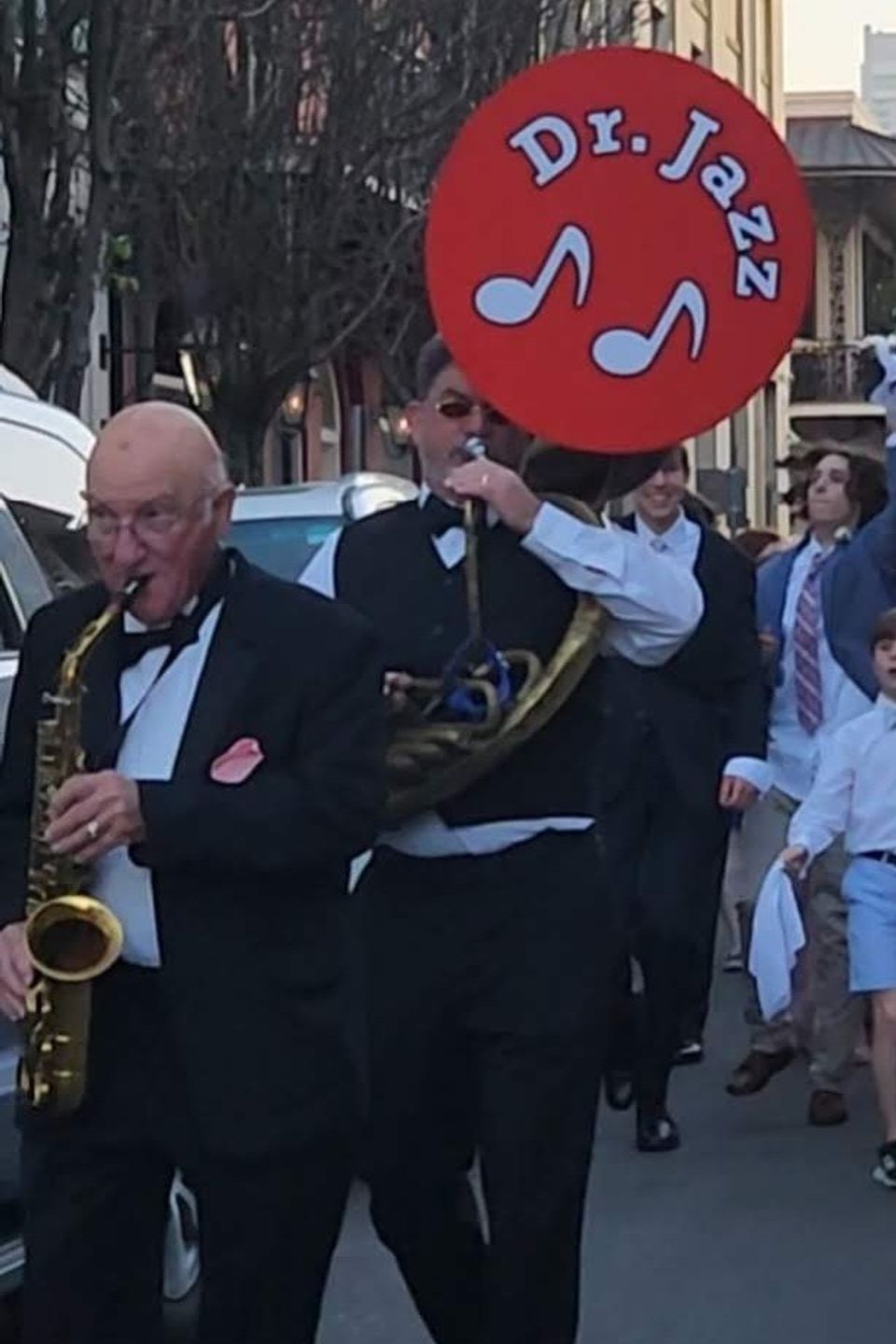 New Orleans jazz band leading a traditional second line parade during a Carpe Diem Events wedding celebration
