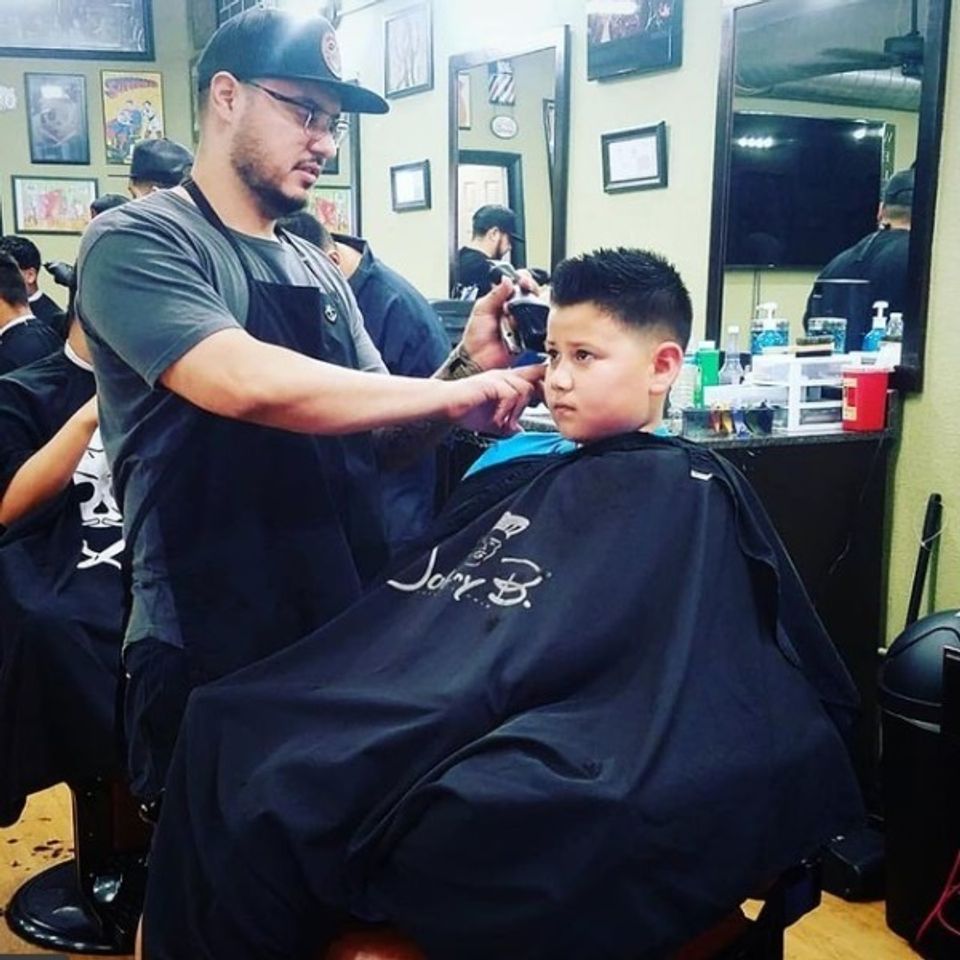 Hairy's barber shop team member providing a jr haircut