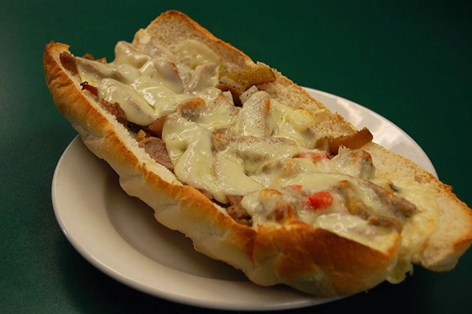 Philly Steak Grinder topped with steak, melted cheese, peppers, and onions at Cocca’s Pizza.