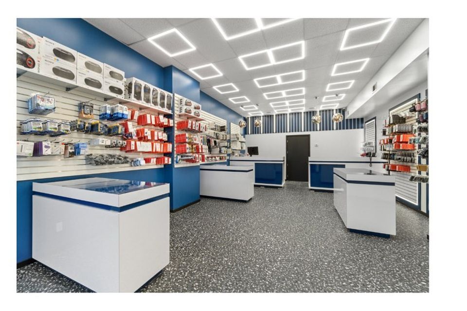 Custom shelving and cabinetry installed in a tech retail store by Ultimate Kitchens.