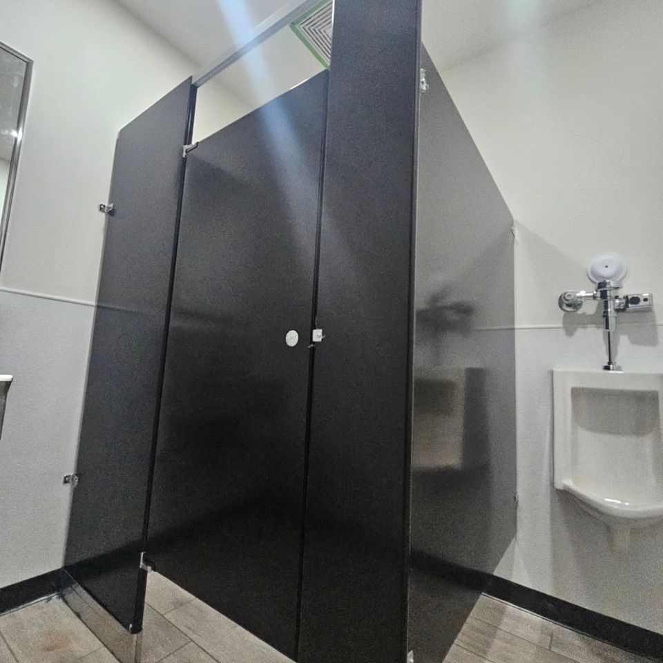 A single black bathroom partition done by Pabst Leyton