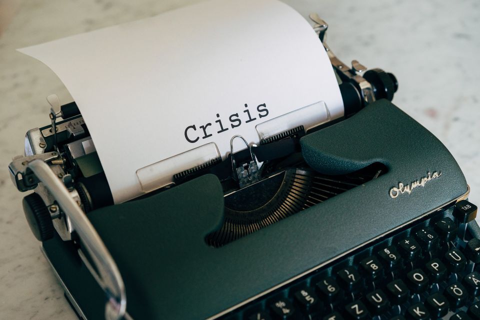 “Close-up of a typewriter typing the word ‘Crisis,’ representing urgent need and support for people in crisis.”
