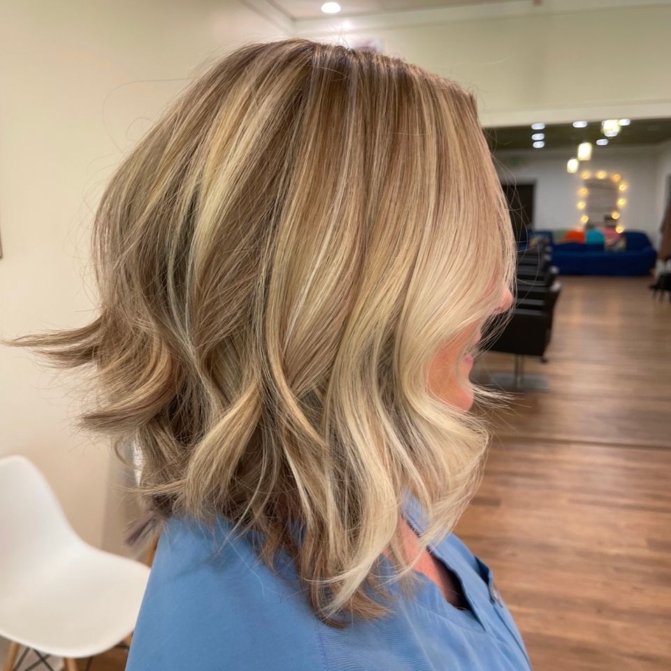 Shoulder length blonde bob with layered waves after color and styling in Columbiana AL