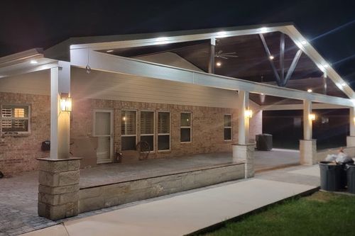 Expansive brick‑patio cover with LED lighting in Huntsville, TX