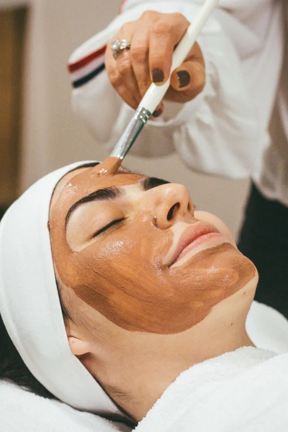 Esthetician student performing facial treatment in skincare training program