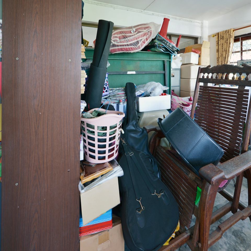 Messy storage room in garage for junk in old house