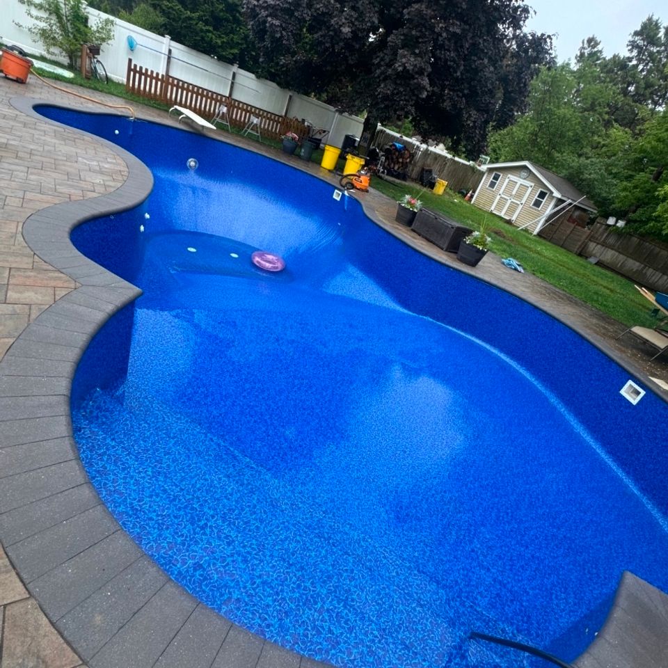 Completed liner replacement on a curved inground pool with paver coping in Long Island NY
