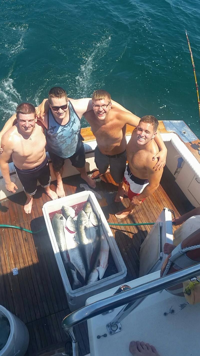 Four men on moving boat cooler of daily catch