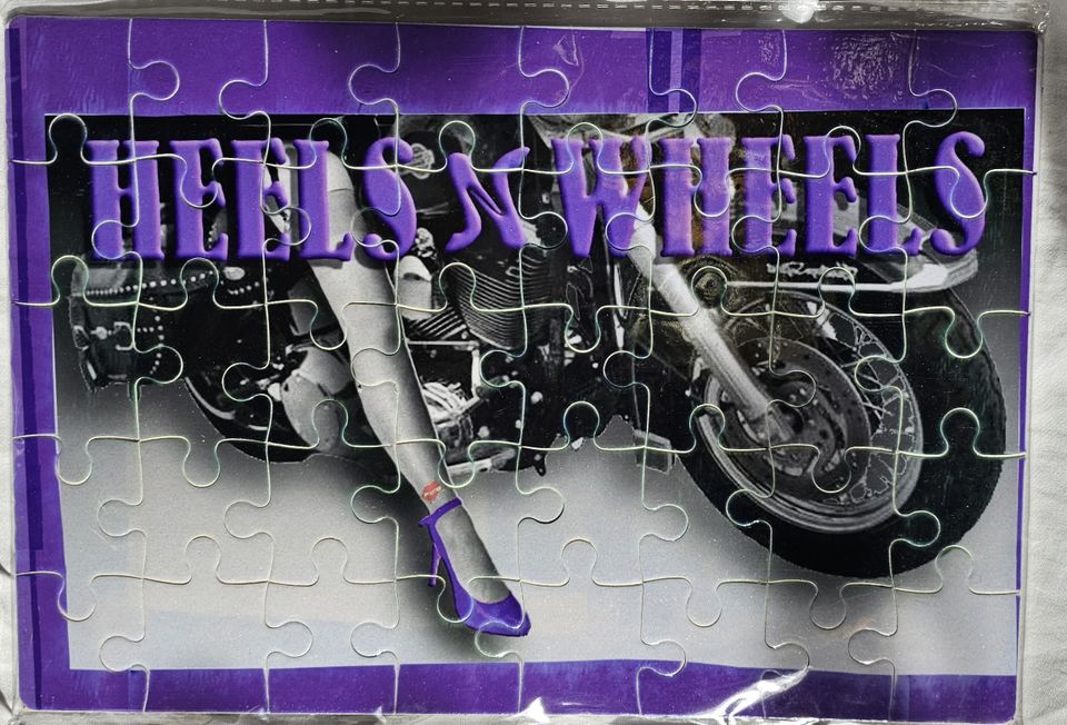 Custom Heels 'n Wheels jigsaw puzzle featuring purple lettering and a motorcycle-themed design.