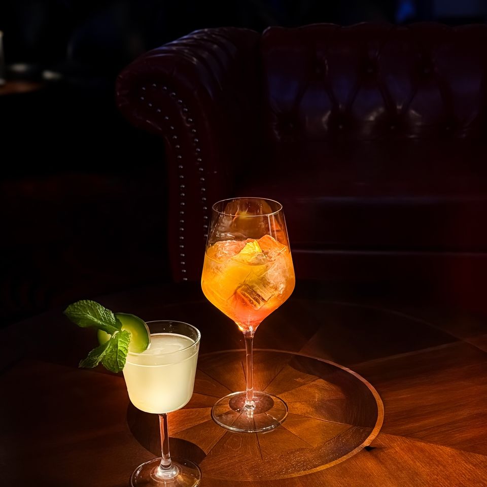 Two handcrafted cocktails on a table at Jilly's in Metairie.