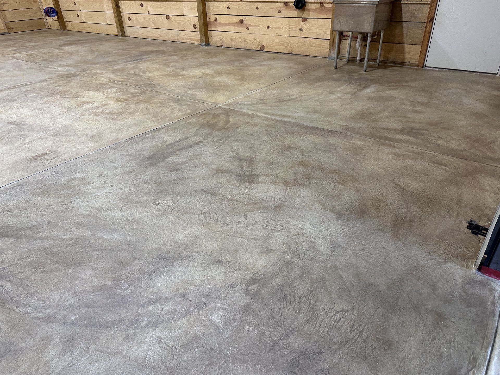 After: detailed view of the finished gray and taupe garage floor