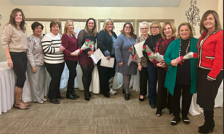 Group of Mahoning Valley Republican Women’s Club members holding flowers and posing together at an event.